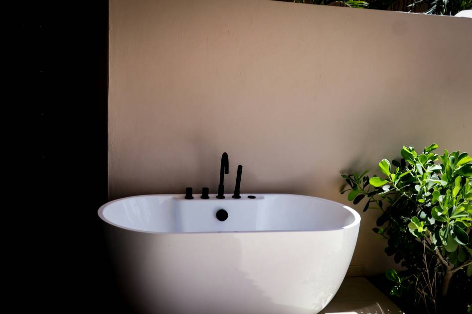 Modern white freestanding bathtub in a minimalist bathroom